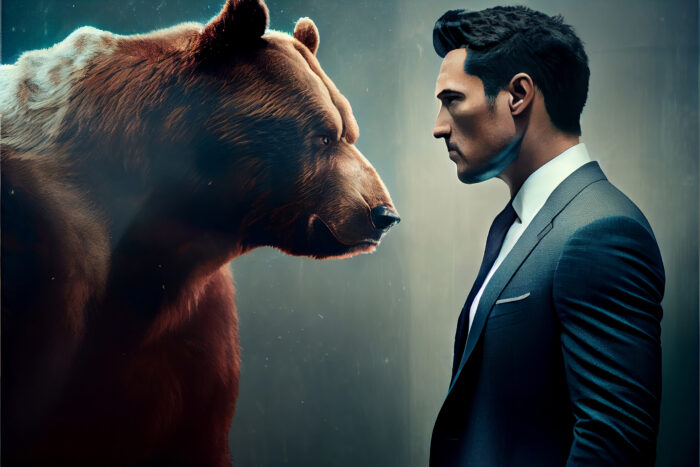 Inwestor stojący naprzeciw niedźwiedzia symbolizującego spadki giełdowe